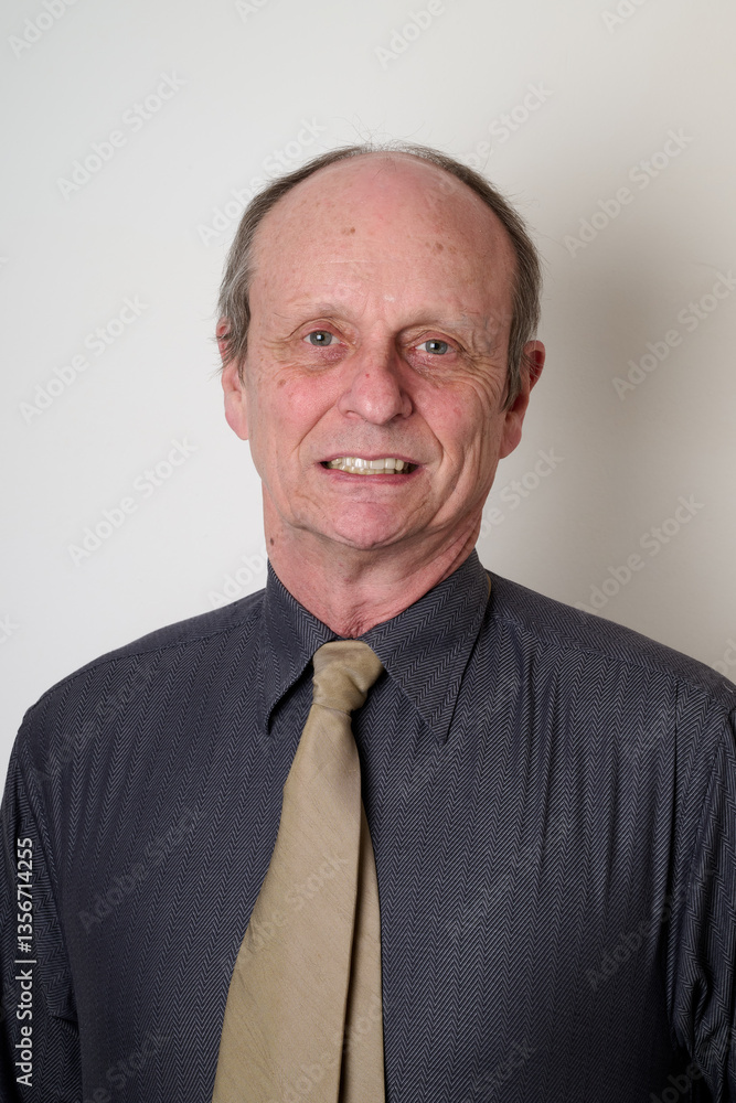 Senior man with a cotton shirt against white wall