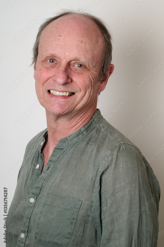 Senior man with a cotton shirt against white wall