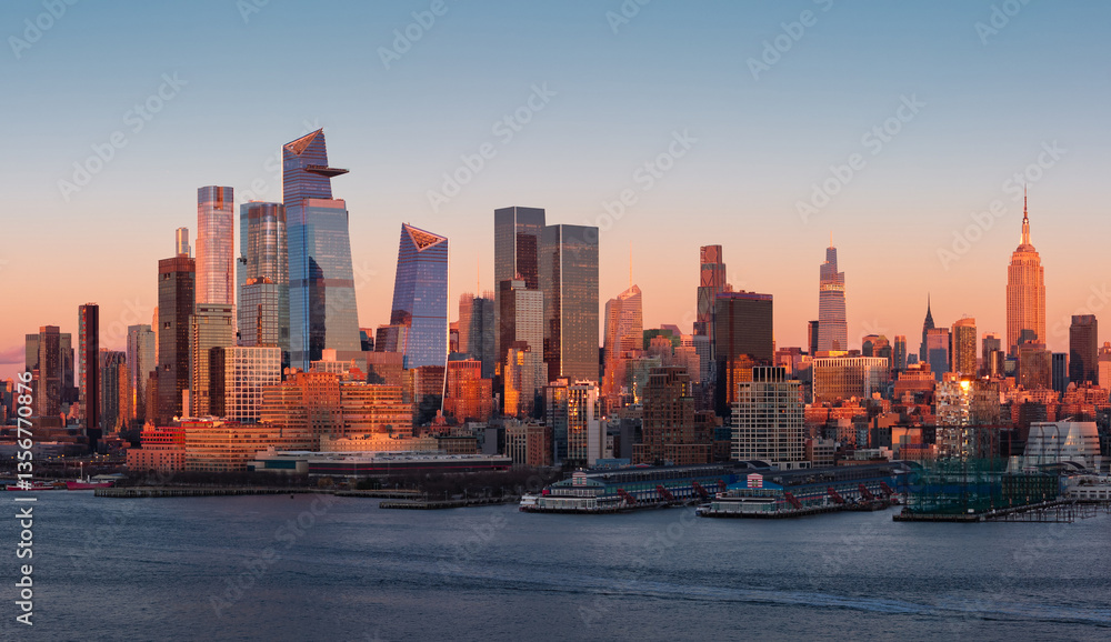 Obraz premium Aerial view of New York City skyline with Hudson River Park and Manhattan skyscrapers at sunset. Midtown high-rises, Hudson Yards and Chelsea Piers