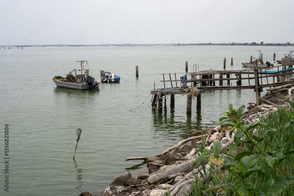 Fototapeta premium Fishing boats near wooden dock in coastal lagoon