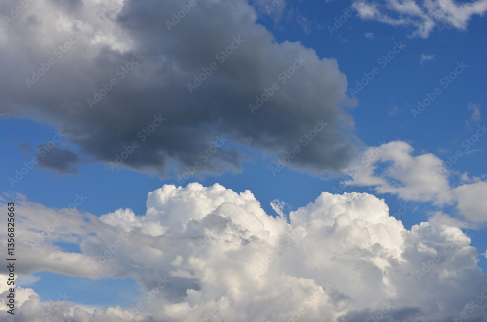 Naklejka premium white and dark Clouds in the blue sky