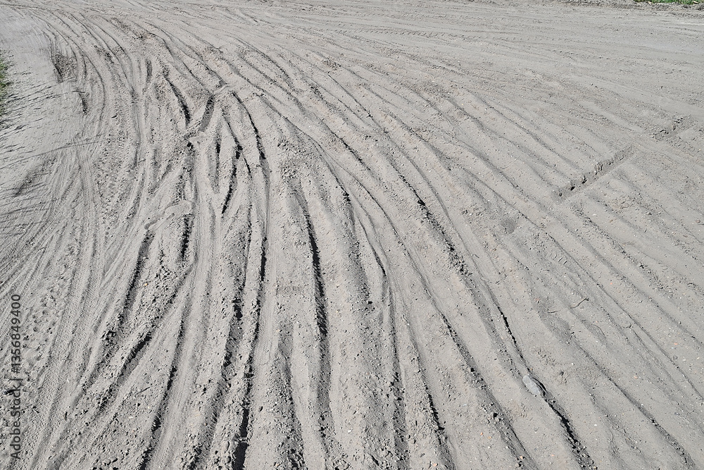 Multiple Bicycle tire tracks in a sandy road