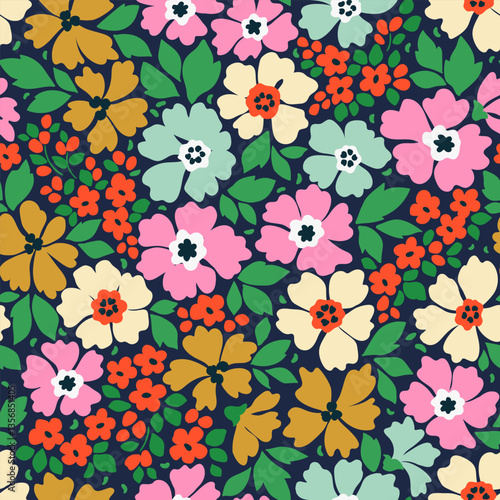 Cute floral background. Floral pattern with small bright hand drawn  flowers on a dark blue background. Seamless pattern for design and fashion prints. Ditsy style. Stock vector illustration.
