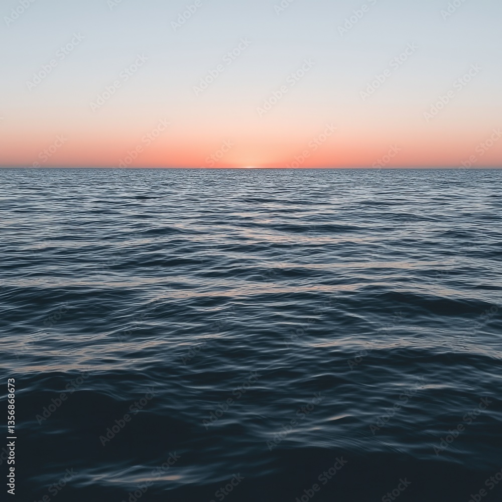Obraz premium Stunning sunset over the ocean with golden hues and reflective waves creating a dreamy landscape