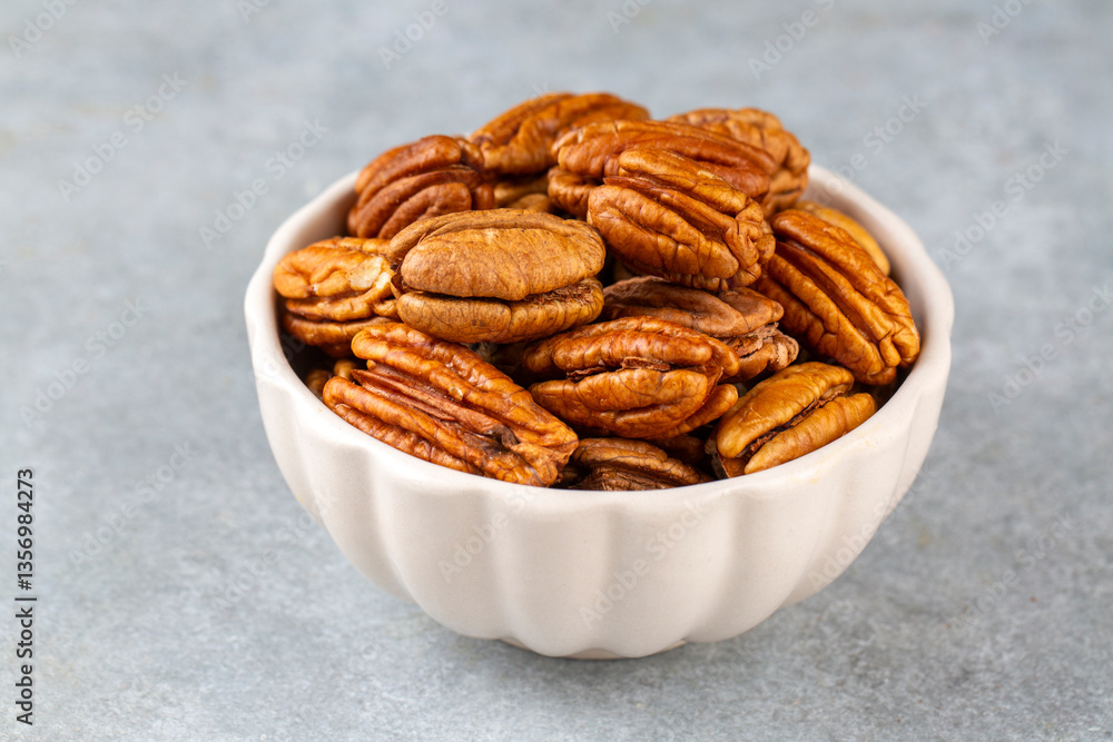 Fototapeta premium Tasty pecan nuts in bowl