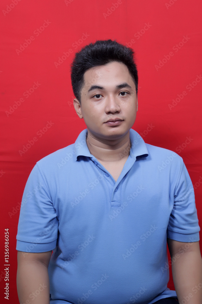 Fototapeta premium Asian man looks sharply at the camera