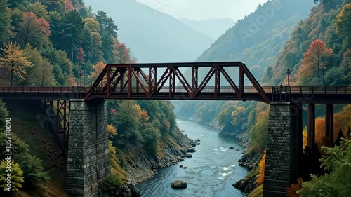 Tranquil River Flows Beneath a Rustic Bridge Amidst Autumn's Embrace