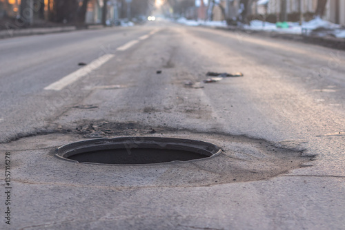 Obraz na płótnie Pothole in the road. Concept of terrible road surface condition