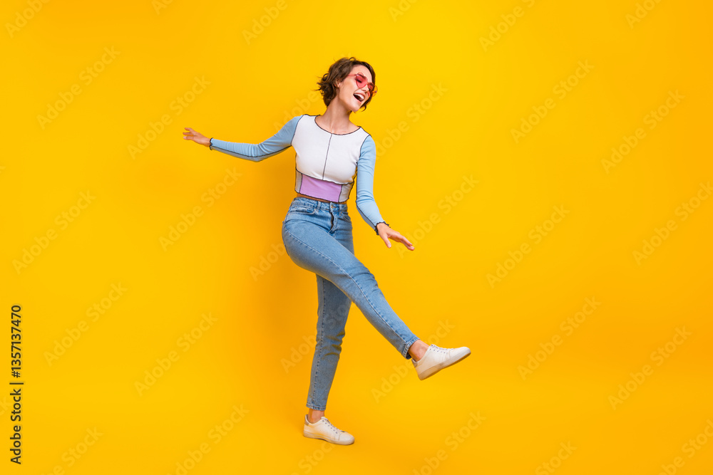 Full size photo of cheerful overjoyed girl good mood chilling dancing isolated on yellow color background Full size photo of cheerful overjoyed girl good mood chilling dancing isolated on yellow color background