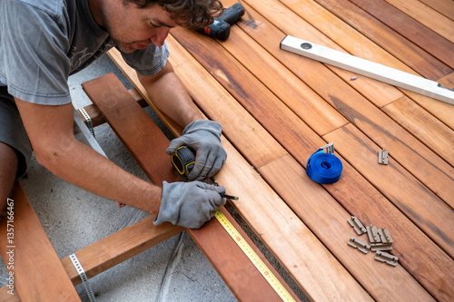 Skilled worker installing wooden deck
