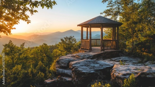 Scenic gazebo overlooking mountain landscape at sunset in nature