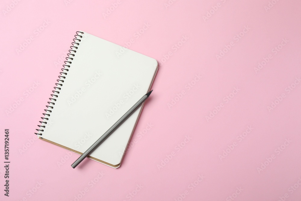 Top view photo of notebook and a pencil on pink background with blank space. Business concept Top view photo of notebook and a pencil on pink background with blank space. Business concept