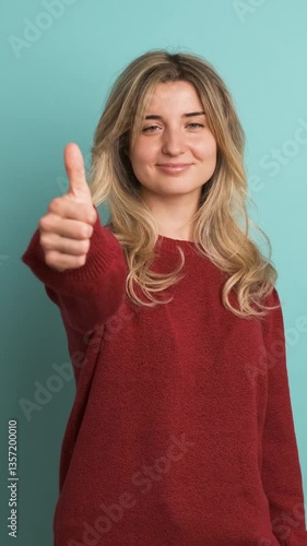 Wallpaper Mural Happy young woman showing thumbs up in blue studio Torontodigital.ca