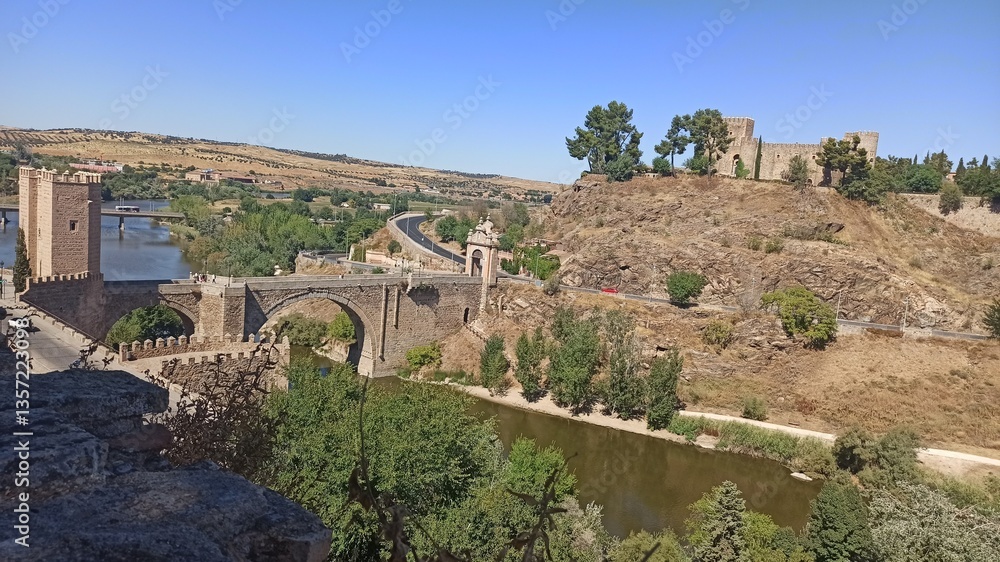Fototapeta premium ancient bridge and ruins on a hill