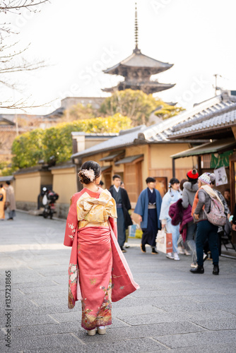 Traditional Elegance in Kyoto. A Woman in Elegant Pink Traditional Japanese Kimono Furisode walking on the street.
