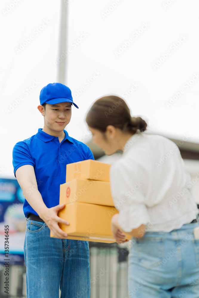 Delivery man wearing blue shirt and box at door for customer order, parcel or goods in delivery service. Woman receiving goods from delivery man. Delivery man wearing blue shirt and box at door for customer order, parcel or goods in delivery service. Woman receiving goods from delivery man.
