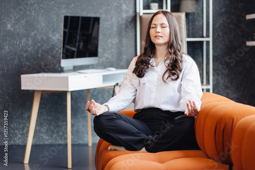 Business concept of meditation and mindfulness in the office during a break for stress relief and focus.