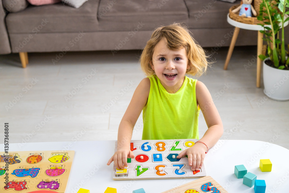 Fototapeta premium Child learns numbers and letters. Selective focus.