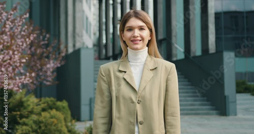 Wallpaper Mural Portrait of caucasian woman looking at camera while standing outside office building. Businesswoman beautiful stylish dressed in jacket posing and smiling near office centre. Torontodigital.ca