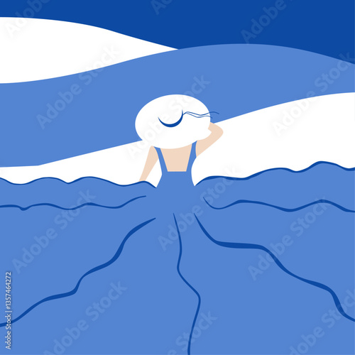 Una mujer en el vestido azul y con el sombrero blanco mira a las olas del mar