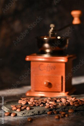 coffee beans scattered on the table. manual coffee grinder