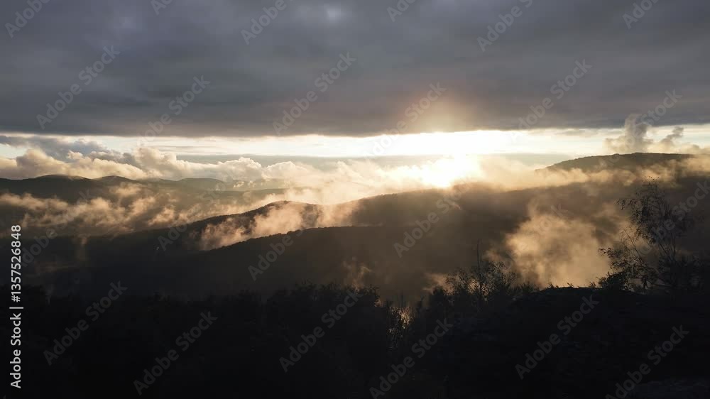 Magical golden sunset above the mountains. Real time rising and swirling mist in the valley of the Zemplen Mountains, Hungary Magical golden sunset above the mountains. Real time rising and swirling mist in the valley of the Zemplen Mountains, Hungary