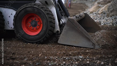 Mini excavator leveling the dirt