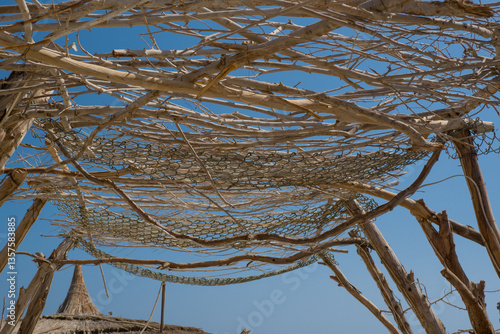 Decorative canopy made of sun sticks against the sky