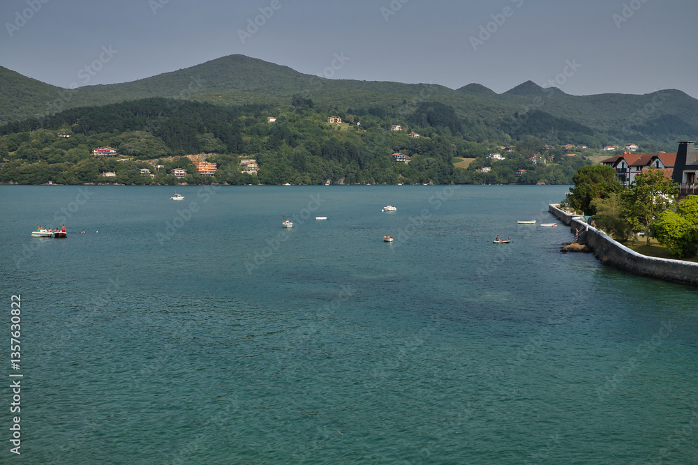 Fototapeta premium Image of fishing and recreational boats, in the waters of the Cantabrian Sea, located on the coast of the province of Vizcaya, in front of the towns of Bermeo and Mundaca. Concept travel, coast, sea.