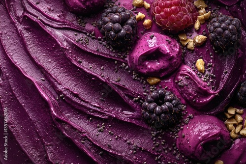 A vibrant close-up of purple açaí bowl topped with blackberries, raspberries, nuts, and seeds, showcasing textures and healthy ingredients.