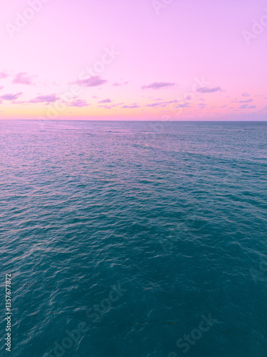 Aerial view of colorful sunset over ocean in Punta Cana.Breathtaking scenery showcases sky painted with stunning hues, while gentle waves reflect evening light. Postcard capturing beauty of tropical