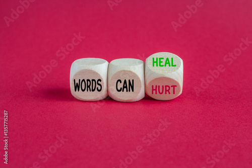 Obraz na płótnie Turned a wooden cube and changes the expression Words can hurt to Words can heal. Beautiful red background. Business concept. w salonie