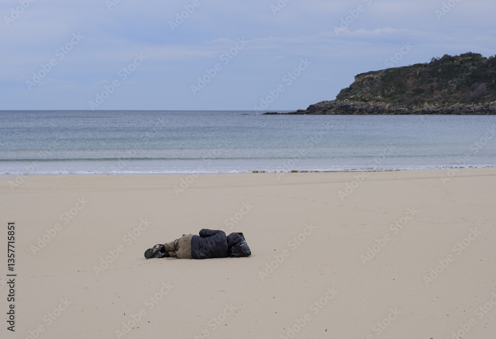 Man lying on the beach.