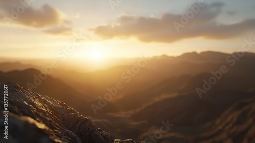 A serene sunset over a mountainous landscape, casting warm hues across the sky and illuminating the rugged terrain.