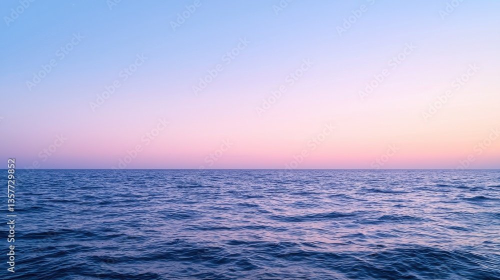 Obraz premium Serene ocean view at twilight, showcasing gentle waves under a gradient sky transitioning from blue to pink.