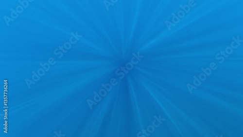 Bright beams of sunlight descend into the ocean's blue depths in Indonesia.