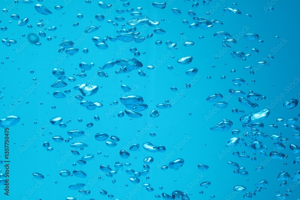 Many water bubbles on blue background, closeup Many water bubbles on blue background, closeup