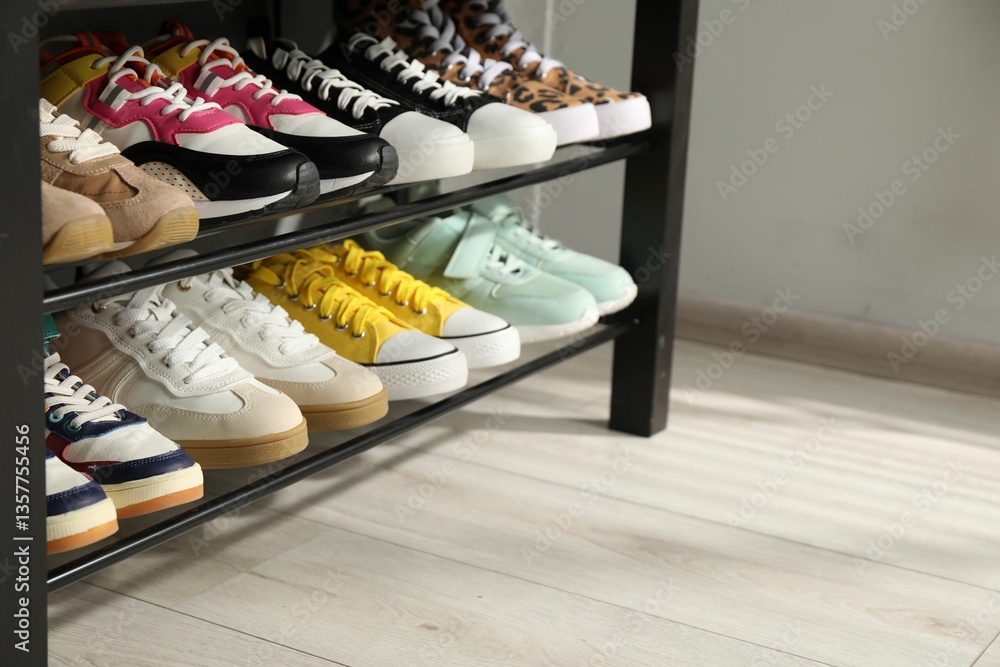 Shoe storage bench with different footwear indoors, closeup. Space for text
