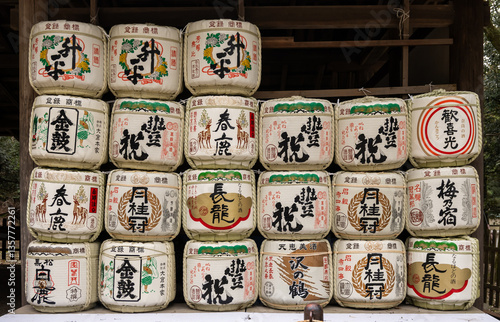 In Nara, Japan, sake barrels kazaridaru stacked, decorated with calligraphy and crests, are offerings to a Shinto shrine, and represent prosperity.