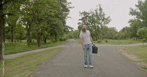 Wallpaper Mural Bearded man walking in a park, facing a choice of paths. He represents decision-making, career choices, and new beginnings. Torontodigital.ca