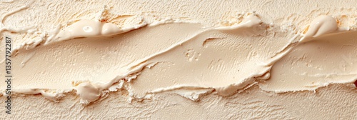 Close up texture of creamy caramel ice cream with swirls of sauce and soft lighting creating a rich dessert backdrop