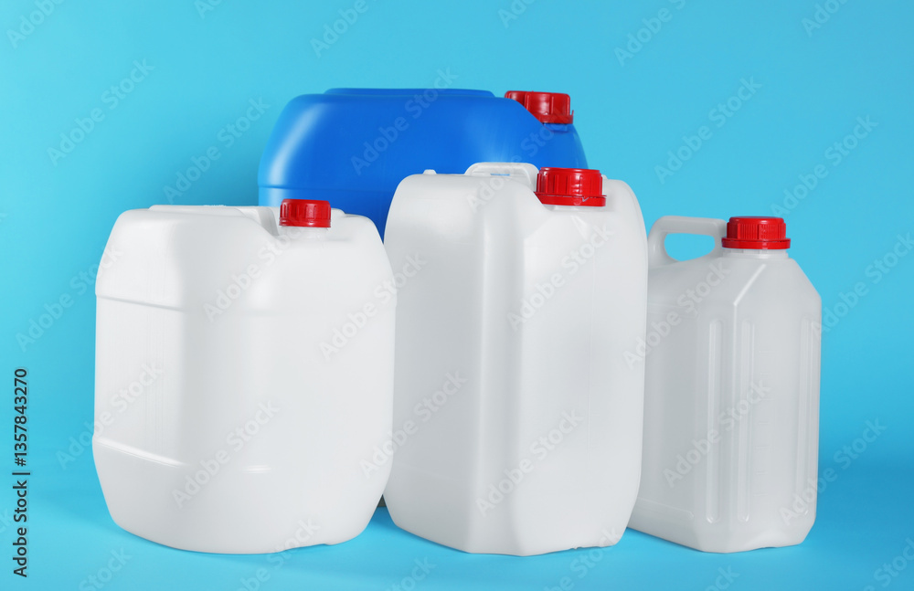 Different plastic canisters on light blue background Different plastic canisters on light blue background