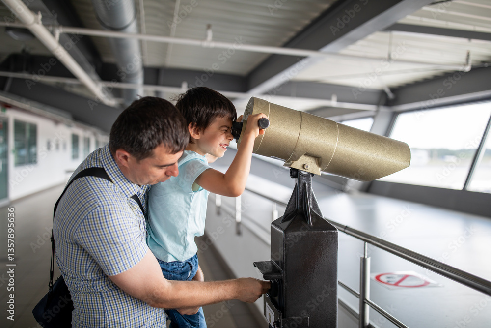 Little boy with father at airport looking at planes