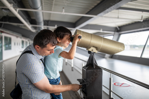 Little boy with father at airport looking at planes