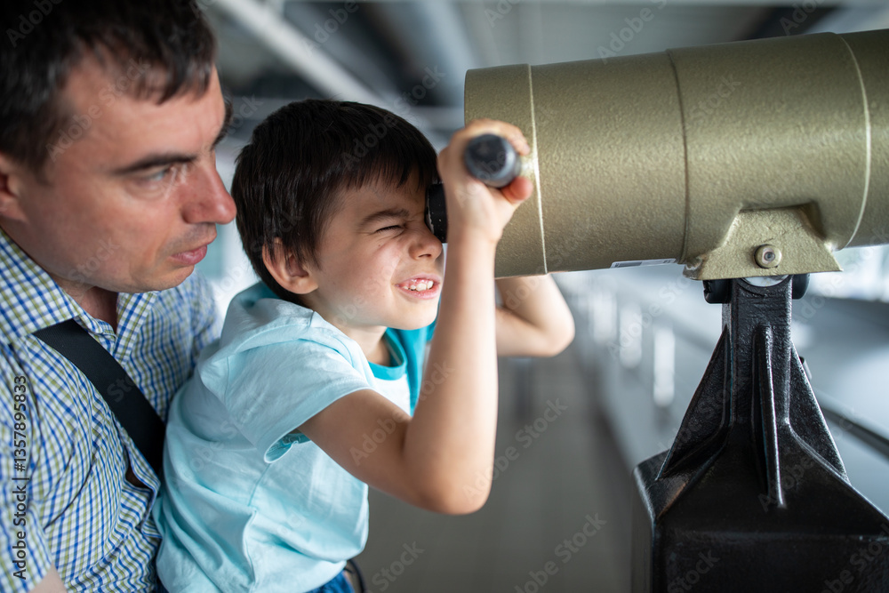 Little boy with father at airport looking at planes