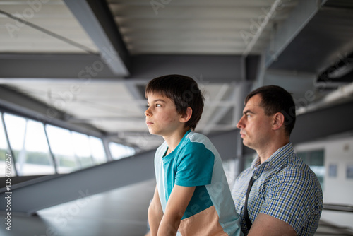 Little boy with father at airport looking at planes