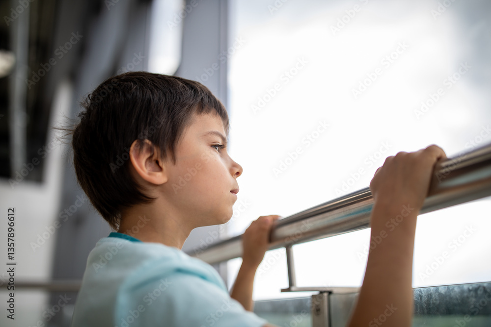 Little boy at airport looking at planes