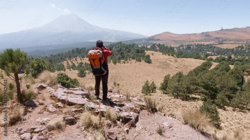 Hiker pointing at popocatepetl volcano in mexico Hiker pointing at popocatepetl volcano in mexico