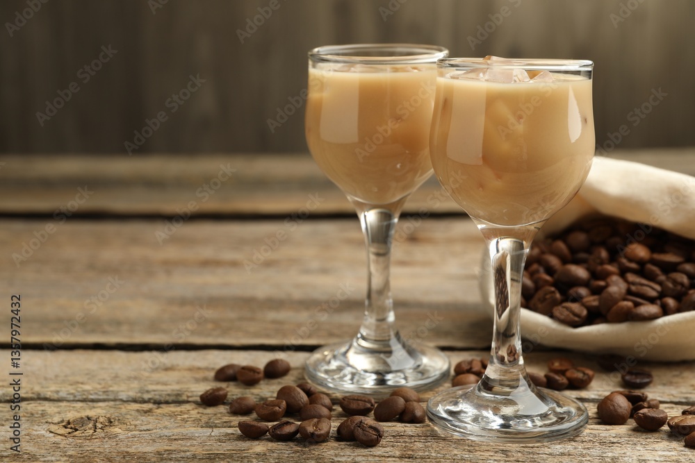 Coffee cream liqueur in glasses and beans on wooden table, closeup. Space for text Coffee cream liqueur in glasses and beans on wooden table, closeup. Space for text