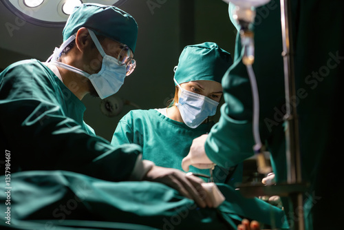 emergency doctor group working using tools to save people. specialist surgical team performing medical tools procedure. medical staff team wearing uniform helping patient in surgery with equipment